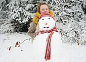 Girl making snowman outdoors