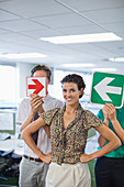 Business people holding arrows in office