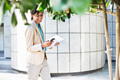 Businesswoman using cell phone outdoors