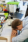 Businessman resting head on desk