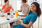 Pregnant woman having glass of juice