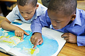 Students using world map in class