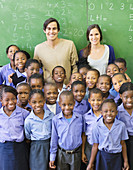 Students and teachers smiling in class