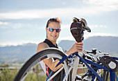 Woman taking bicycle off cycle rack