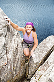 Climber scaling rock face