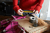 Woman measuring upholstery webbing