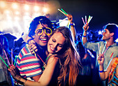 Couple with glow sticks hugging