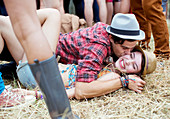 Couple kissing in grass at music festival