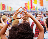 Woman forming heart-shape with hands