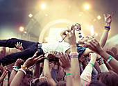 Performer crowd surfing at music festival