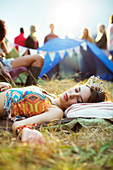 Woman sleeping outside tent