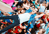 Performer singing and crowd surfing