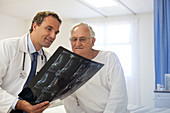 Doctor and patient examining x-rays