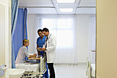 Doctor and nurse talking to patient room