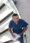 Nurse writing on clipboard on steps