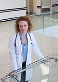 Doctor leaning on banister hallway