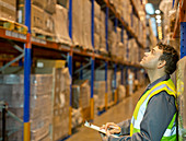 Worker checking boxes in warehouse