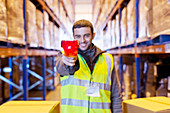 Worker holding scanner in warehouse