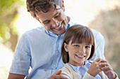 Father and daughter hugging outdoors