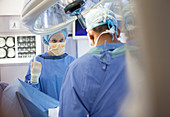 Surgeons standing over patient