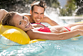 Couple relaxing in swimming pool