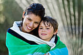 Mother and son wrapped in towel