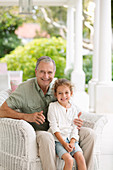 Older man with granddaughter on porch