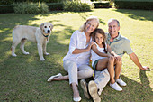 Older couple smiling with granddaughter