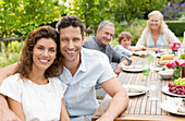 Couple smiling at table outdoors