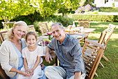 Older couple and granddaughter smiling