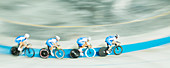 Track cycling team racing in velodrome