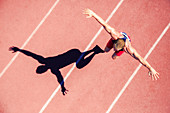 Track and field athlete jumping on track