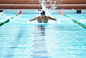 Swimmer racing in pool