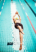 Swimmer diving into pool