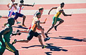Relay runners racing on track