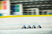 Track cycling team racing in velodrome