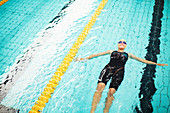 Swimmer floating in pool