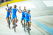 Track cycling team celebrating on track