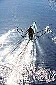 Man rowing scull on lake