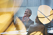 Smiling businessman clapping in meeting