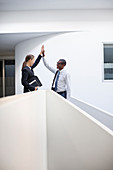 Businessman and businesswoman high fiving