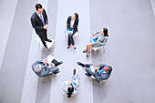 Businessman standing on chair