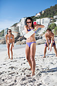 Woman playing paddle ball on beach