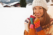 Portrait of smiling woman in snowy field