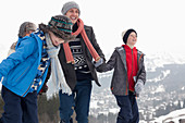 Happy family walking in snow