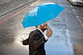 Businessman with tiny umbrella