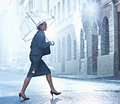 Happy businesswoman with umbrella