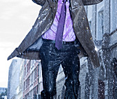 Businessman running in rain