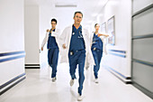 Doctors rushing down hospital corridor