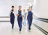 Doctors rushing down hospital corridor
